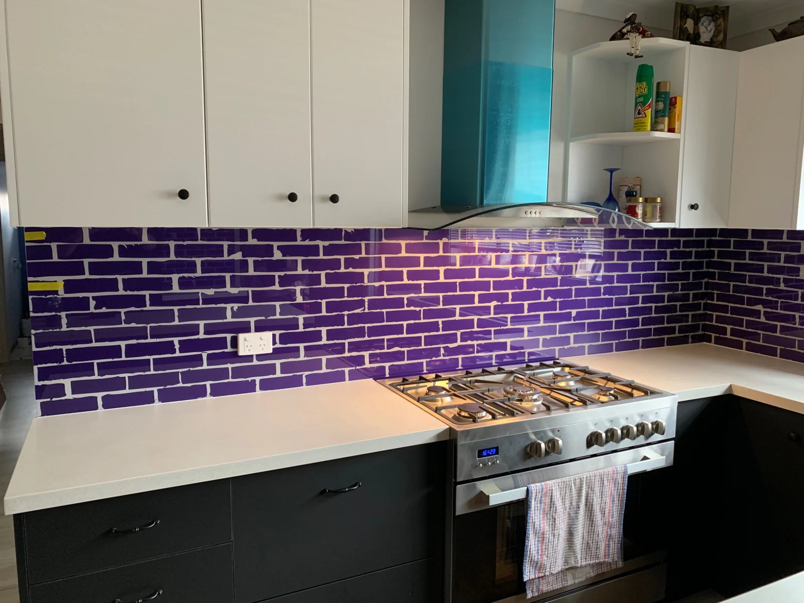 Purple brick-effect glass splashback in a kitchen