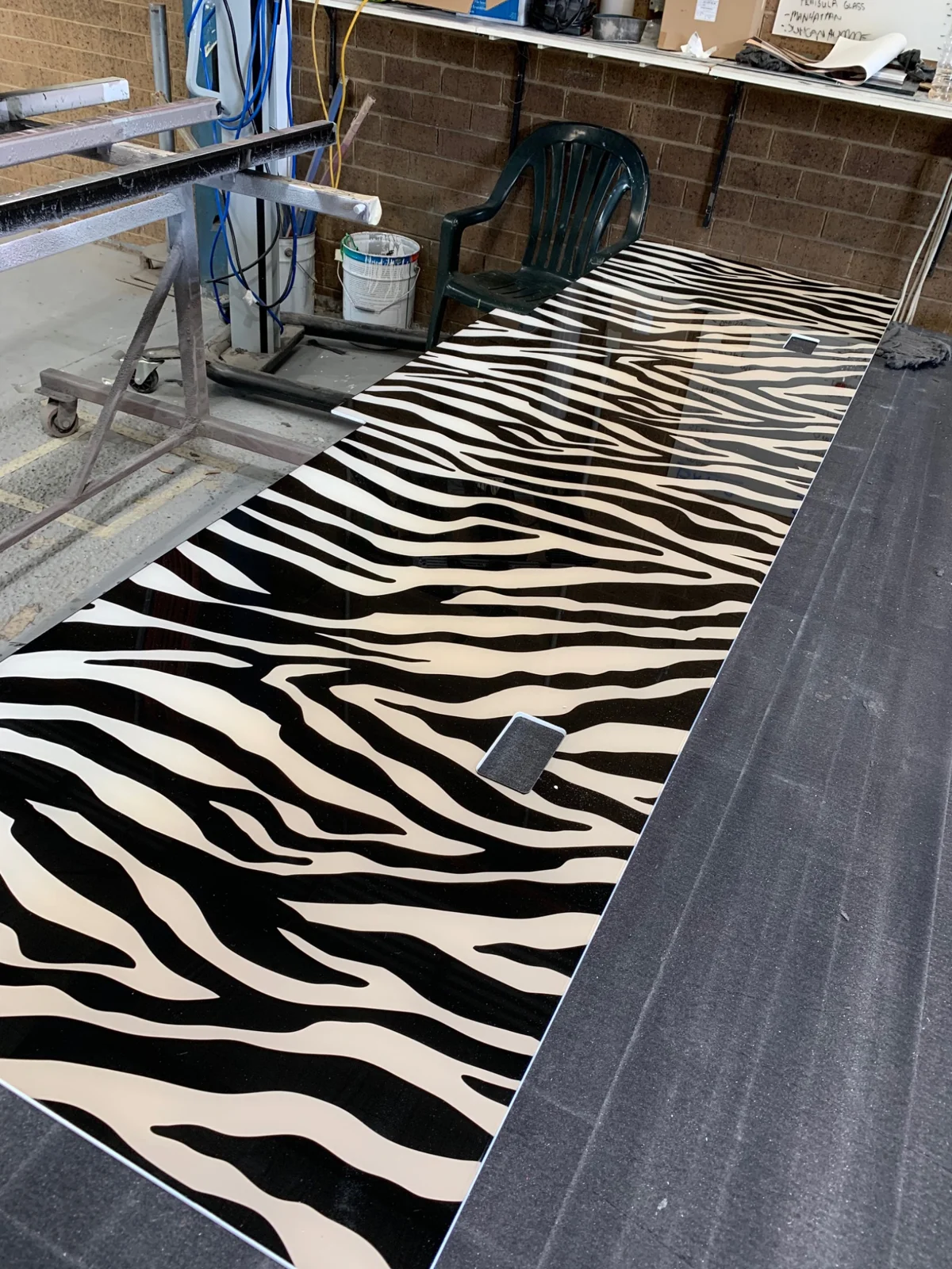 Long zebra-print panel on a workshop bench