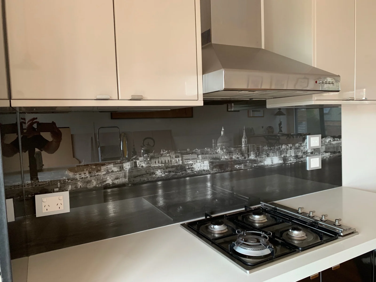 Monochrome city skyline printed behind a kitchen cooktop
