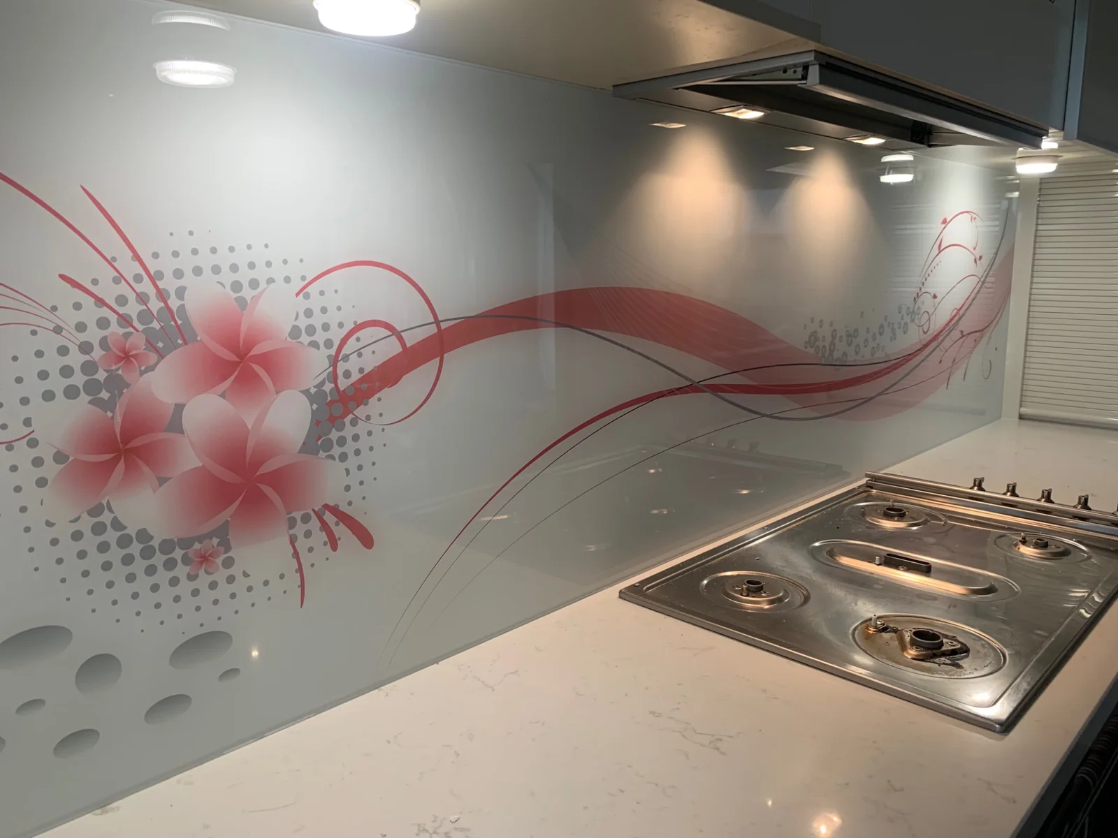 Pink flower and sweeping line artwork on a glass splashback