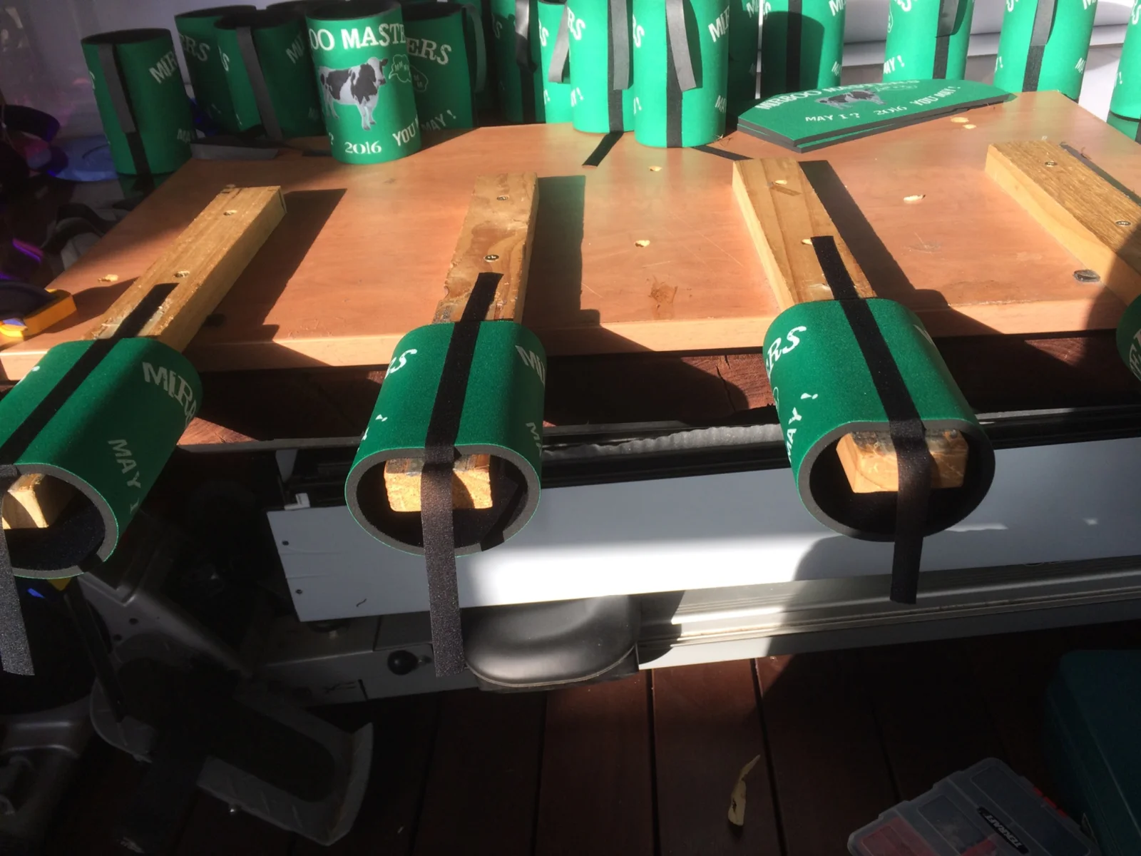 Green stubby holders being made in a heat press