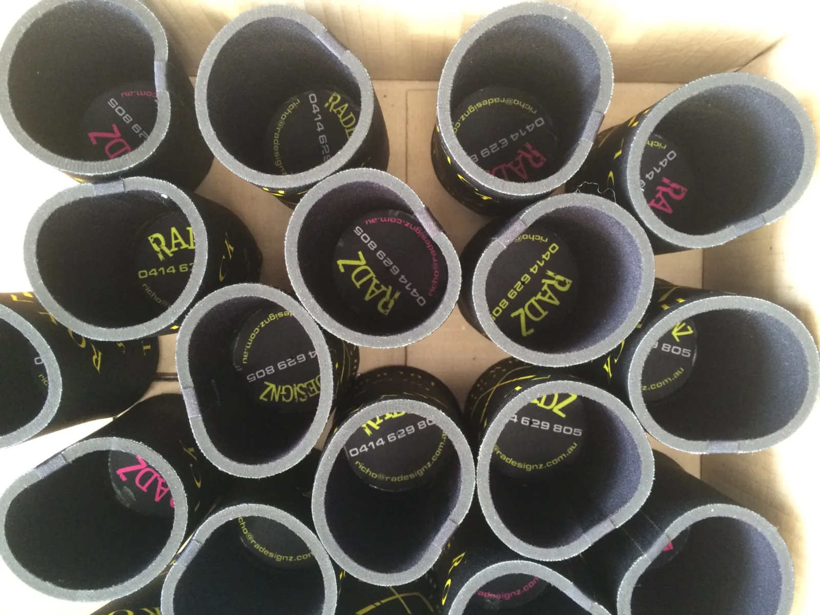 Branded stubby holders arranged in a box
