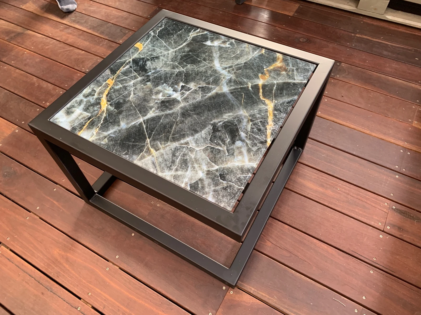 Top view of the charcoal marble-effect printed glass tabletop
